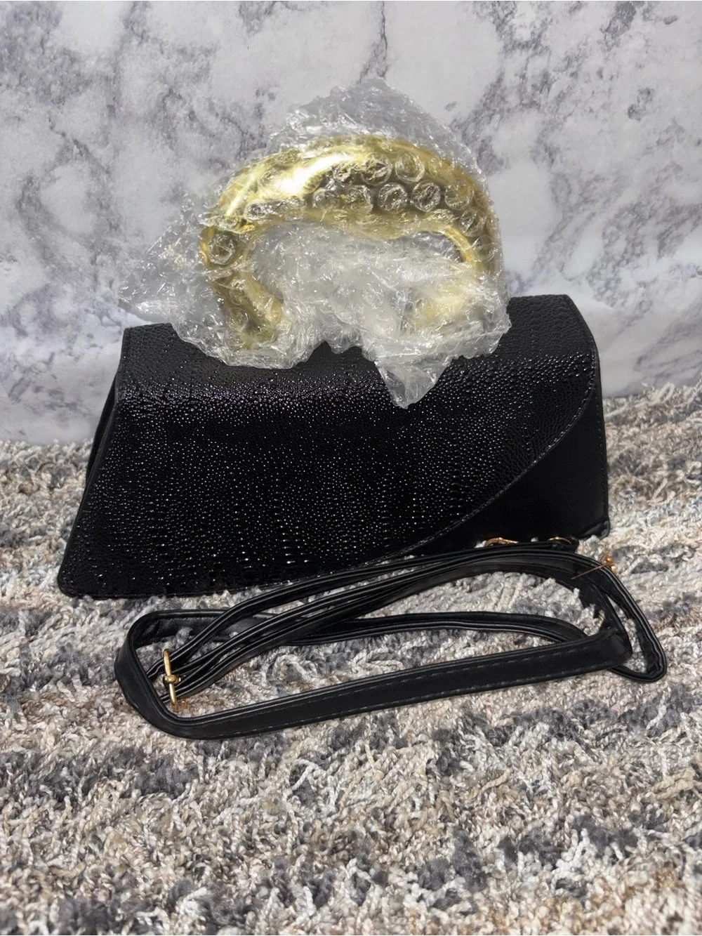 Elegant Black Textured Clutch with Gold Accent Handle